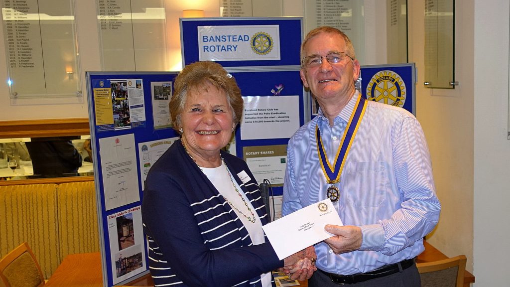 Judy Sarssam accepting a cheque from Banstead Rotary Club