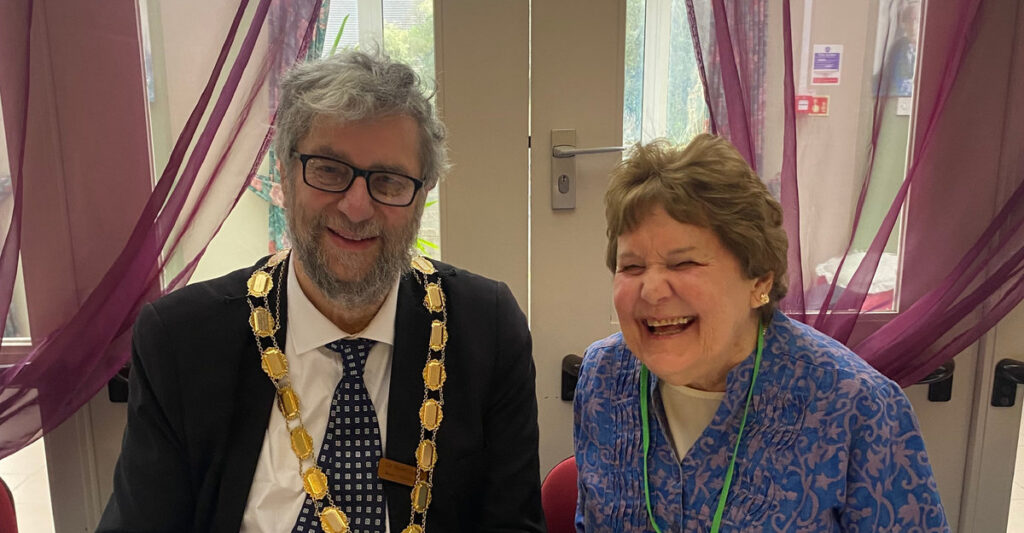 The Epsom and Ewell Mayor in full regalia sat next to Judy, the talking newspaper chair. Both are laughing