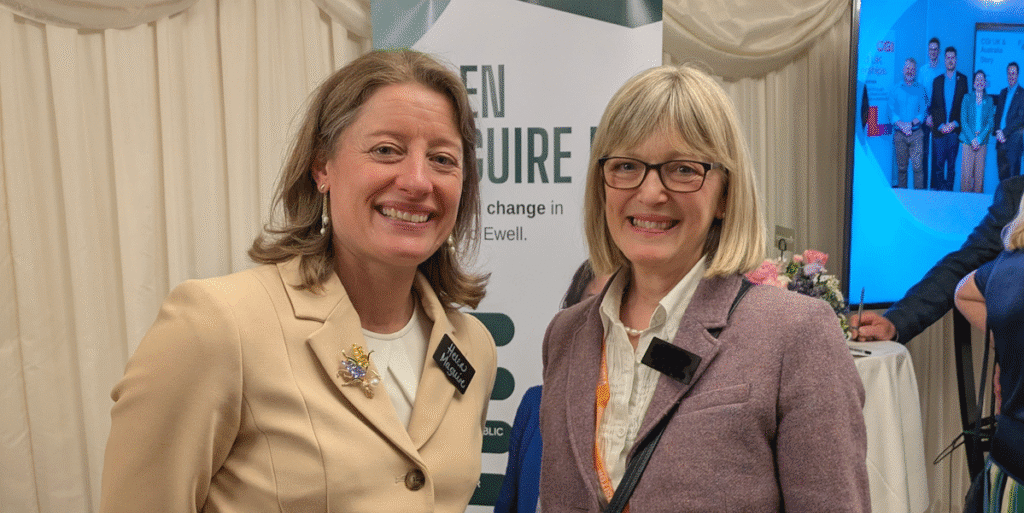 Two smartly dressed women smiling at the camera