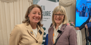 Two smartly dressed women smiling at the camera