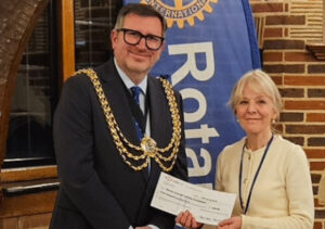 A cheque being handed over by the Mayor of Reigate & Banstead to the Talking Newspaper